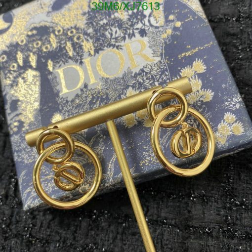 Gold Dior earrings on branded box