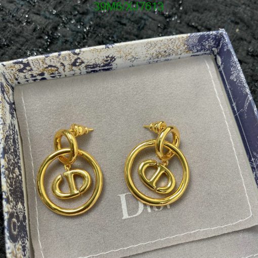 Gold designer logo earrings in presentation box.