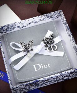 Elegant Dior invitation with butterfly designs and pearl detail.