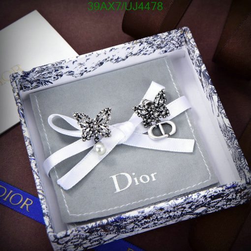 Elegant Dior invitation with butterfly designs and pearl detail.