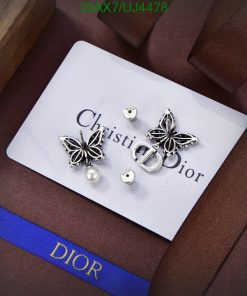 Dior designer earrings and logo on luxury presentation card.