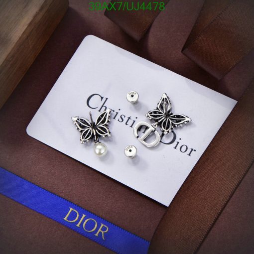 Dior designer earrings and logo on luxury presentation card.