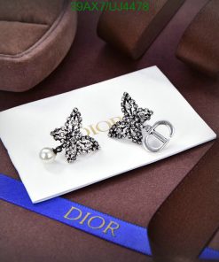 Dior butterfly earrings and logo on luxury packaging.