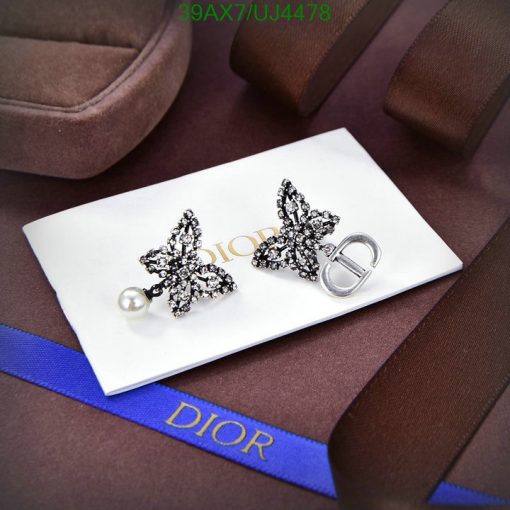 Dior butterfly earrings and logo on luxury packaging.