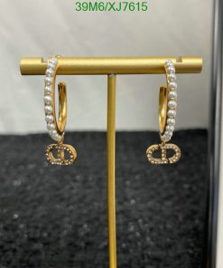 Pearl hoop earrings with diamond accents on display.