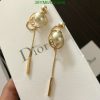 Elegant pearl and gold dangle earrings on display.