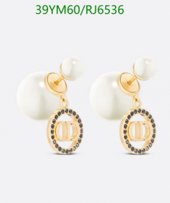 Pearl drop earrings with gold accents on white background.