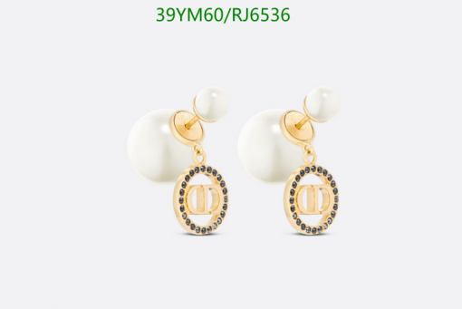 Pearl drop earrings with gold accents on white background.