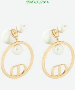 Gold hoop pearl earrings on white background.