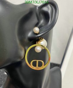 Elegant pearl hoop earring on black mannequin.