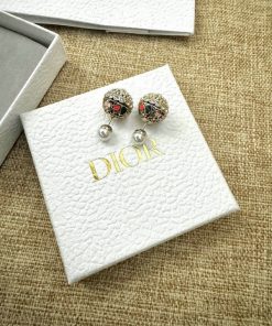 Dior earrings on branded box cloth background