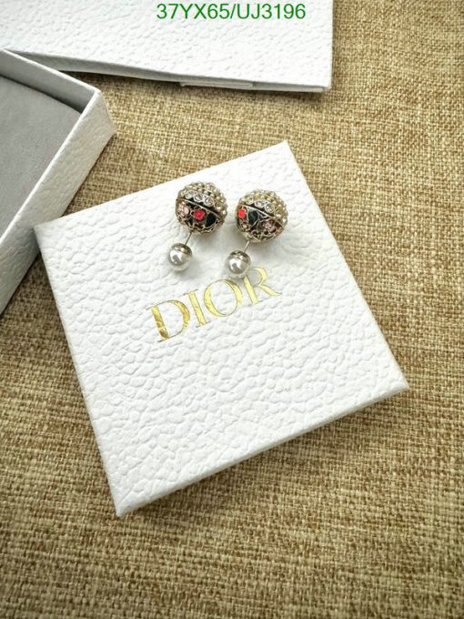 Dior earrings on branded box cloth background