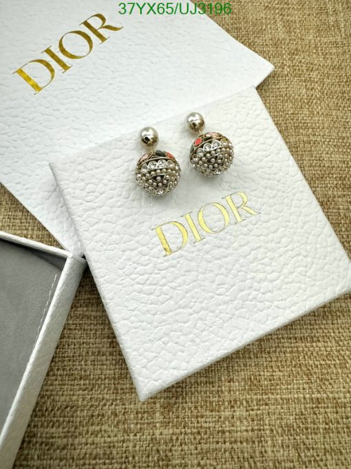 Elegant designer stud earrings on branded packaging.