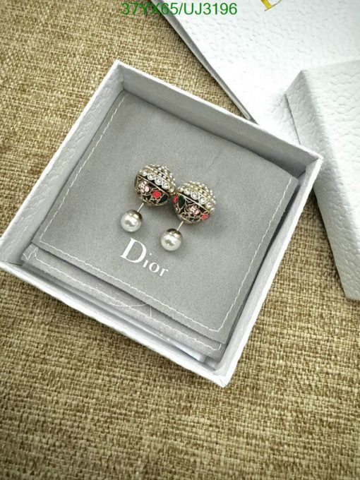 Dior earrings in branded box on textured surface