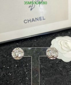 Chanel earrings with white flower and packaging.