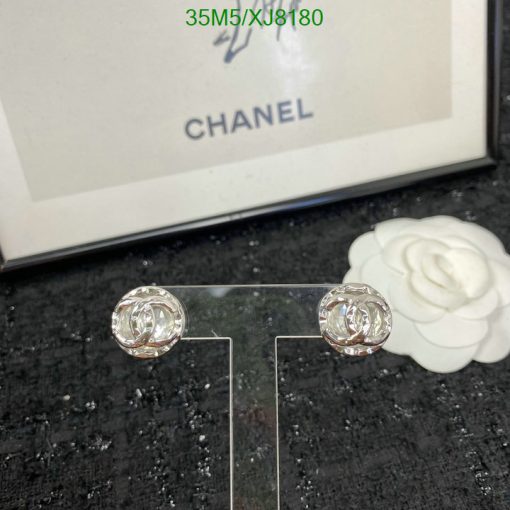 Chanel earrings with white flower and packaging.