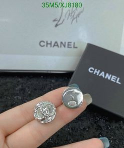 Chanel button close-up with packaging.