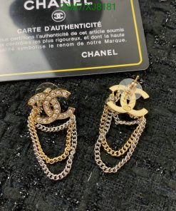 Chanel logo earrings with chains on a dark background.