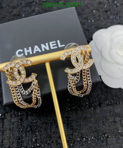 Chanel logo earrings with rhinestones and chains on display.