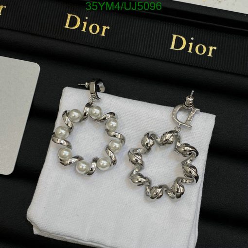 Dior pearl and chainlink hoop earrings on display.