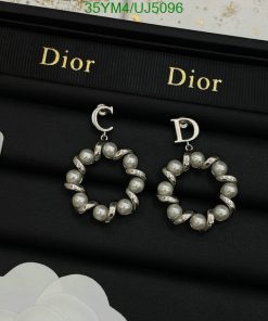 Pearl hoop earrings on designer branded case.