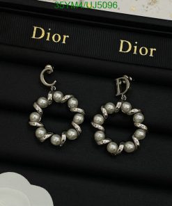 Pearl hoop earrings on Dior branded display.