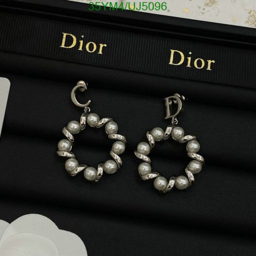 Pearl hoop earrings on Dior branded display.