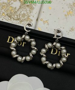 Pearl Dior logo earrings on branded fabric