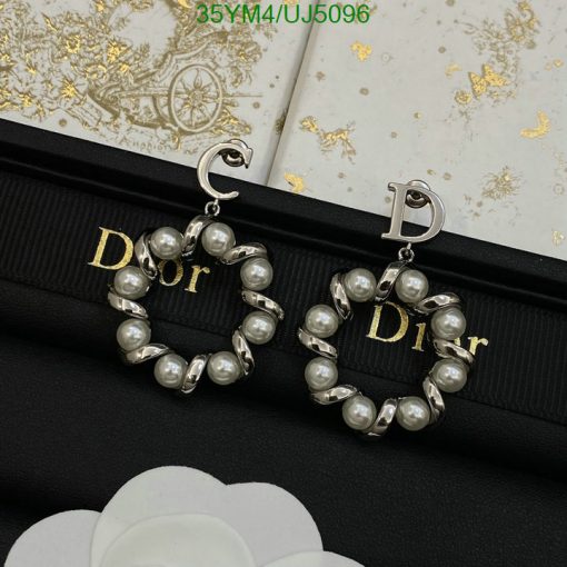 Pearl Dior logo earrings on branded fabric