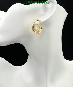 Gold hoop earring on mannequin bust.