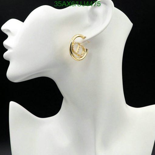 Gold hoop earring on mannequin bust.