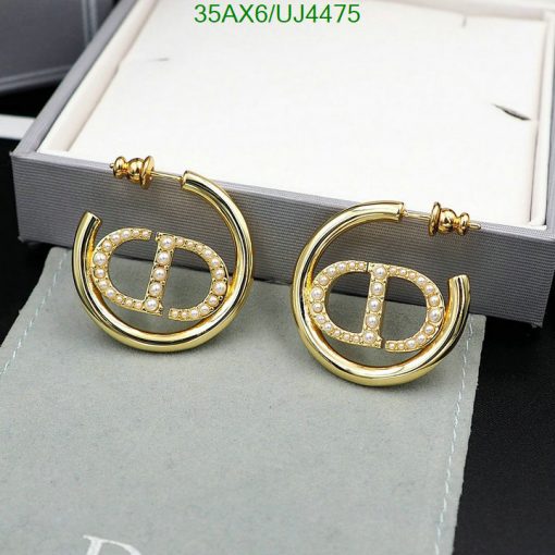 Gold hoop earrings with diamonds on display.