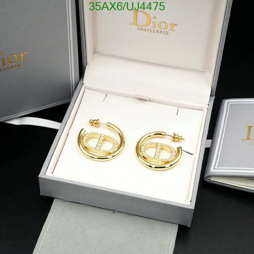 Gold Dior earrings in branded box.