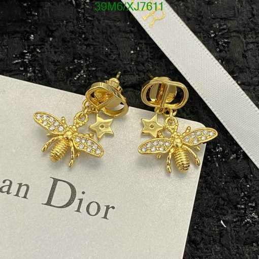 Gold bee-shaped earrings with sparkling stones on card.