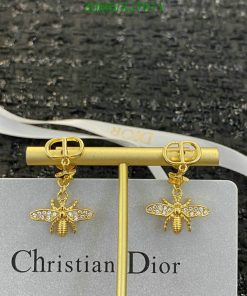 Dior gold bee earrings with diamonds on display