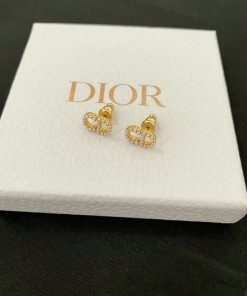 Dior gold-tone heart-shaped earrings on branded box.