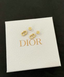 Gold earrings on branded box.