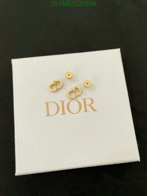 Gold earrings on branded box.