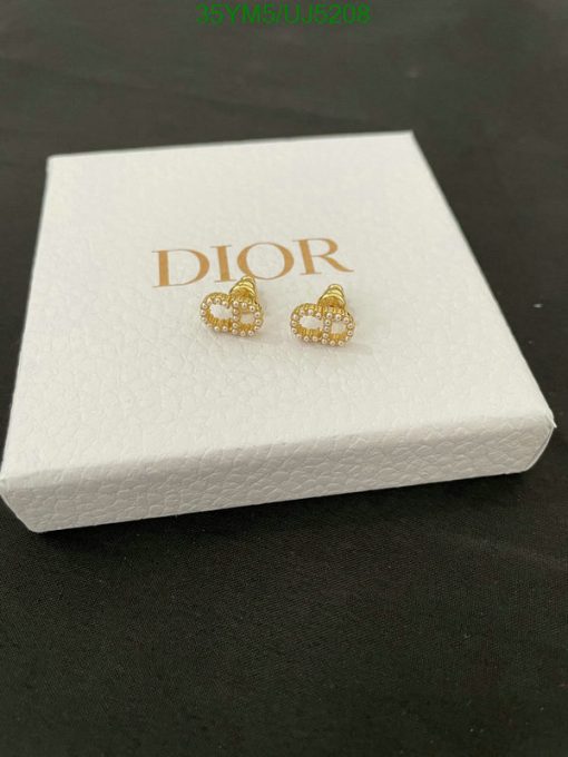 Dior heart-shaped earrings on white display box.