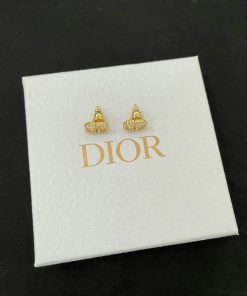 Gold Dior earrings on branded white box