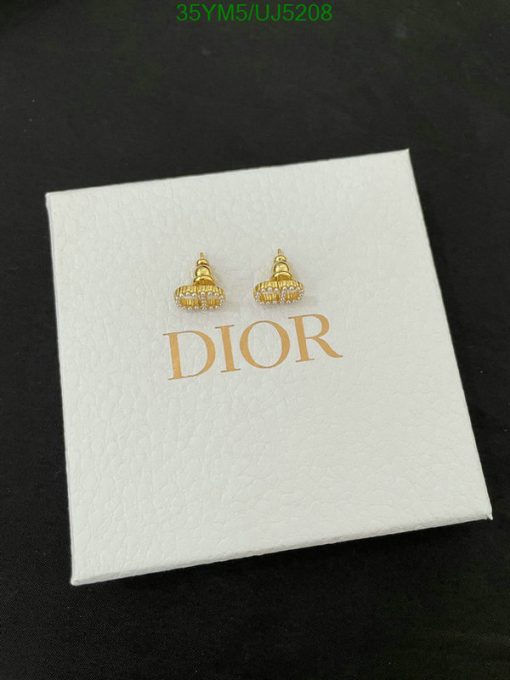 Gold Dior earrings on branded white box