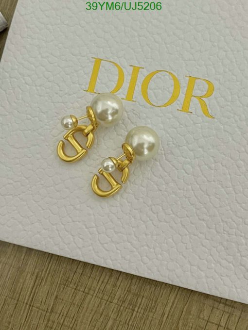 Pearl earrings with gold accents on branded box.