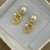 Pearl earrings with gold accents in box.