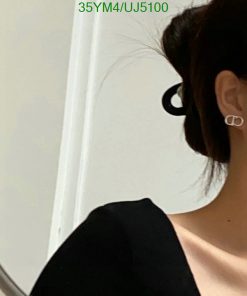 Woman with earrings, partial profile view.