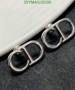 Designer cufflinks on gray background.