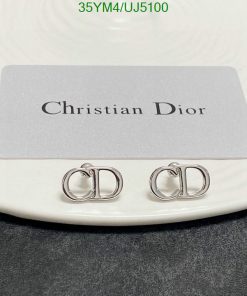 Christian Dior branded earrings on display.