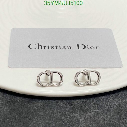 Christian Dior branded earrings on display.