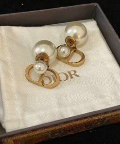 Pearl earrings in box with designer logo.