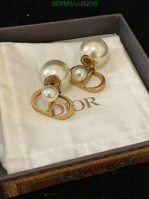 Pearl earrings in box with designer logo.