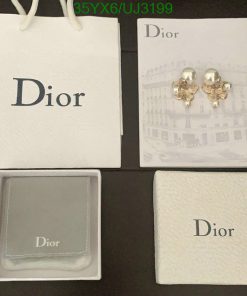 Dior branded packaging and pearl earrings on display.